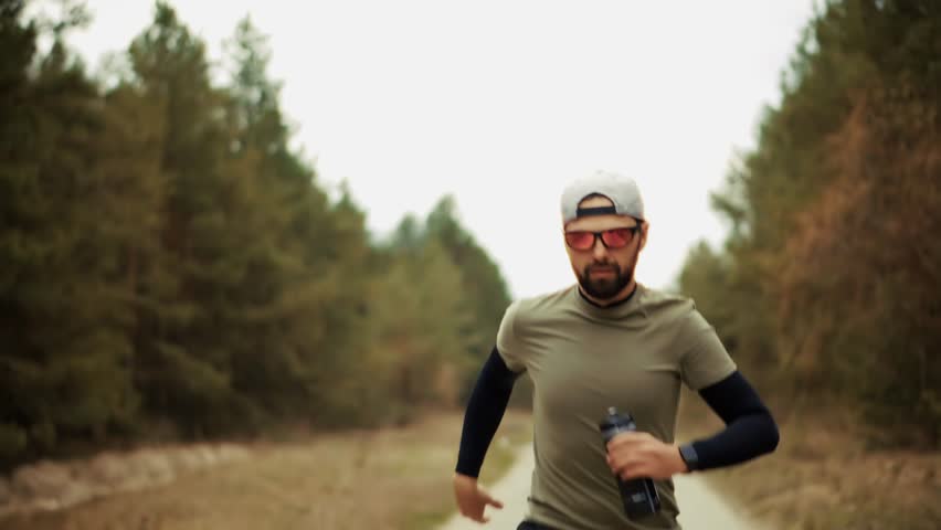 Sporty Man Running. Runner Jogging Physical Wellness Routine. Endurance Workout Trail Running. Cardio Training Morning Run. Fitness Exercise Outdoors Afternoon Fitness.Athlete Training Running Workout