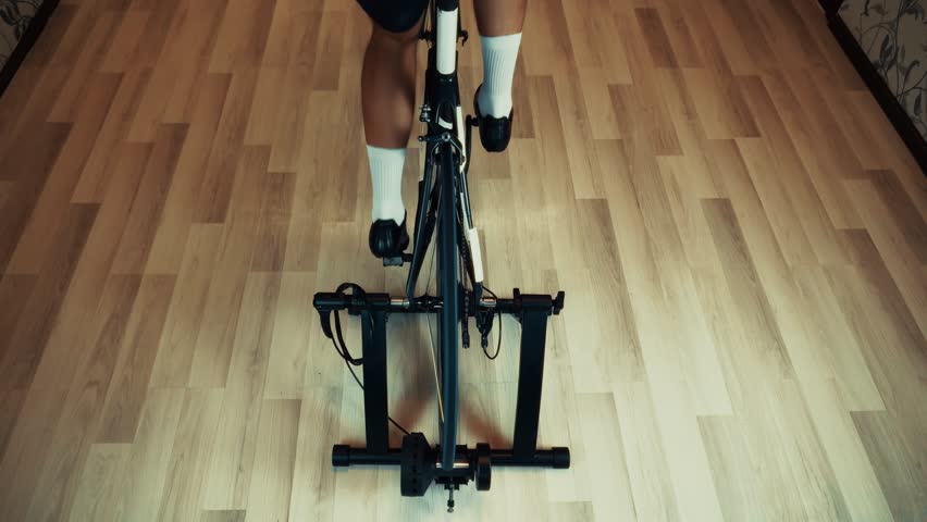 Cyclist Training On Indoor Bicycle Trainer. Home Cycling Workout, Fitness And Cardio Exercise Indoors Sportive Activity. Stationary Bike Training Winter Cycling Preparation. Bicycle Trainer   Exercise