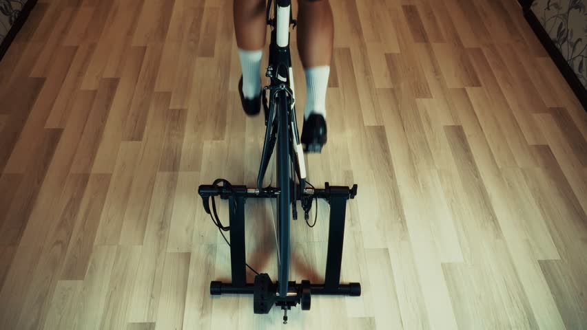 Cyclist Training On Indoor Bicycle Trainer. Home Cycling Workout, Fitness And Cardio Exercise Indoors Sportive Activity. Stationary Bike Training Winter Cycling Preparation. Bicycle Trainer   Exercise