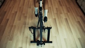 Cyclist Training On Indoor Bicycle Trainer. Home Cycling Workout, Fitness And Cardio Exercise Indoors Sportive Activity. Stationary Bike Training Winter Cycling Preparation. Bicycle Trainer   Exercise - Powered by Shutterstock - Get 15% off with code: PIKWIZARD15