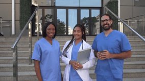 Video of smiling Multiracial diverse medical team gesturing thumbs up outside hospital - Powered by Shutterstock - Get 15% off with code: PIKWIZARD15