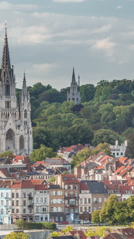 Aerial evening view of Notre Dame de Laeken church spires timelapse in Brussels, Belgium. Neo-gothic architecture surrounded by historic facades, lush green park areas and picturesque urban scenery