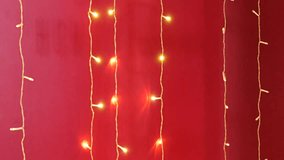 Vertical strands of warm-toned, glowing fairy lights against a vibrant red backdrop. Great for abstract holiday overlays, text backgrounds, and festive ambiance. - Powered by Shutterstock - Get 15% off with code: PIKWIZARD15