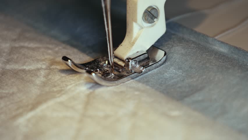 Sewing machine in action as it creates beautiful patterns on fabric in a cozy workshop setting during the afternoon