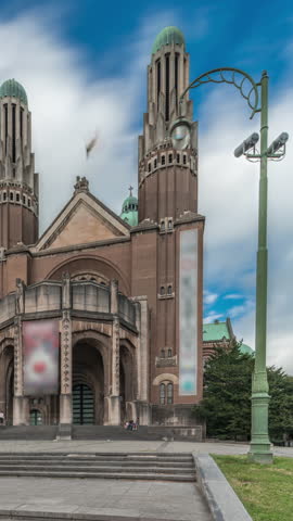 Timelapse hyperlapse of the National Basilica of the Sacred Heart in Brussels, Belgium. A Roman Catholic Minor Basilica with an Art Deco design, seen front view with stairs under a cloudy sky