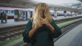 Senior woman with clenched fists smiling and cheering on train platform inside building; joy celebration. - Powered by Shutterstock - Get 15% off with code: PIKWIZARD15