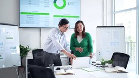 Asian professionals analyze financial reports. Collaborative meeting discussing investment strategy company performance data and market trends in bright office environment - Powered by Shutterstock - Get 15% off with code: PIKWIZARD15