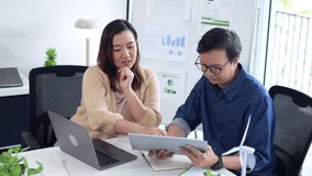 Professional Asian adults brainstorming innovative renewable energy strategies in a modern office. Data analysis drives eco friendly business solutions. - Powered by Shutterstock - Get 15% off with code: PIKWIZARD15