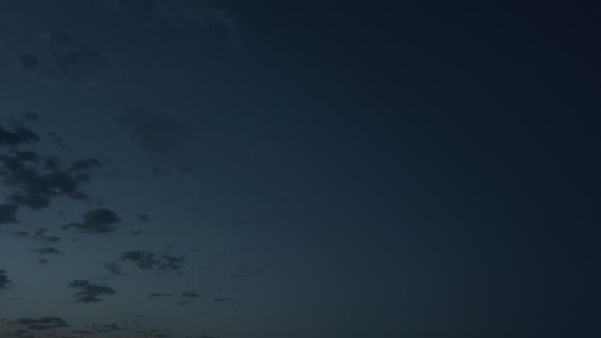 Sky with cloud balls between dusk and night