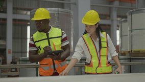 Industrial diversity team. African American man worker recording data on tablet while Asian woman engineer measures metal coil dimensions. Factory quality control, logistics, warehouse meeting - Powered by Shutterstock - Get 15% off with code: PIKWIZARD15
