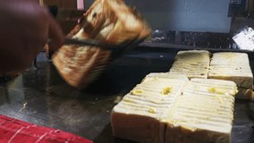 How to fry Roti Bakar Bandung, or Bandung Toast, is a popular street food in Indonesia. The thick, sweet bread is baked and usually served with various toppings - Powered by Shutterstock - Get 15% off with code: PIKWIZARD15