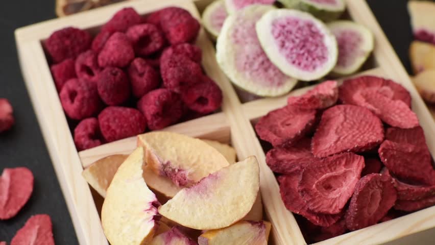 Box of dried fruits strawberries, raspberries, figs and peaches as ingredients for desserts. Dried fruits as food background