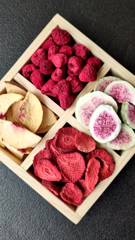 Box of dried fruits strawberries, raspberries, figs and peaches as ingredients for desserts. Dried fruits as food background