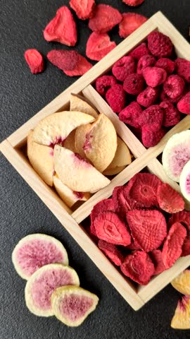 Box of dried fruits strawberries, raspberries, figs and peaches as ingredients for desserts. Dried fruits as food background