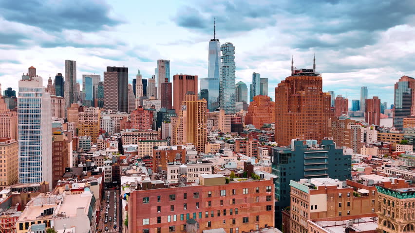 Skyline of beautiful New York midtown under the cloudy sky. Drone footage over the multi-storied buildings at daytime.