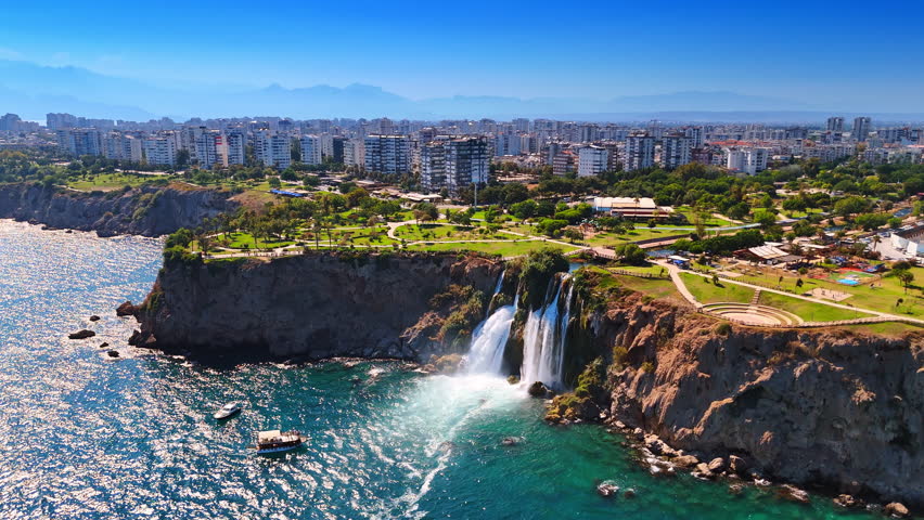 Stunning green park zone at the rugged rocky shore of the Mediterranean Sea. Aerial perspective on the beautiful Duden Waterfalls in Antalya Province, southern Turkey.