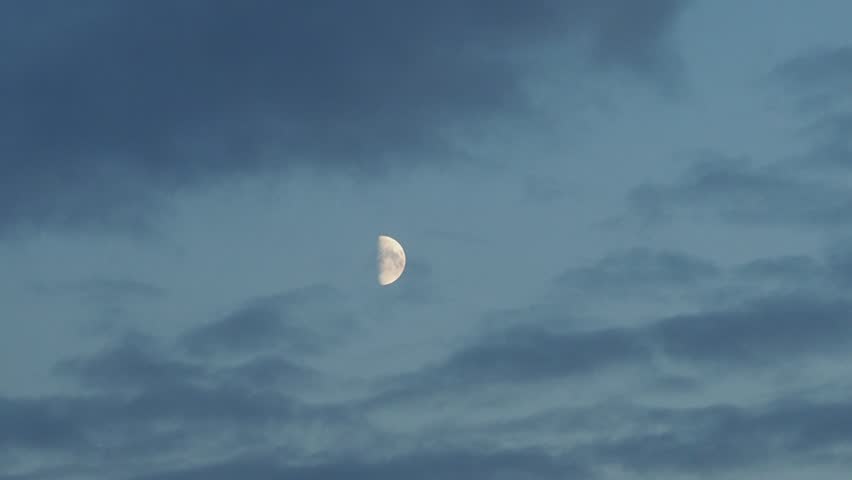 Moon in the blue sky with clouds background. 