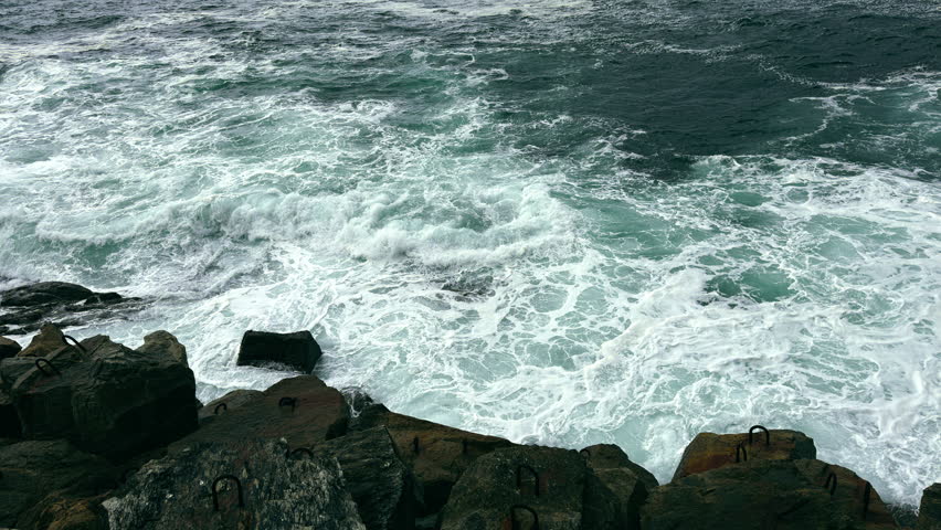 Ocean Waves Crashing Against Rocky Coastline