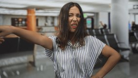 Woman with hands on hips and squinting face in airport terminal, striped shirt visible; frustration travel delay. - Powered by Shutterstock - Get 15% off with code: PIKWIZARD15