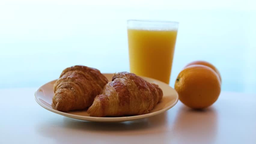 Breakfast served with coffee, orange juice, croissants, cereals, scrambled eggs and pancakes.