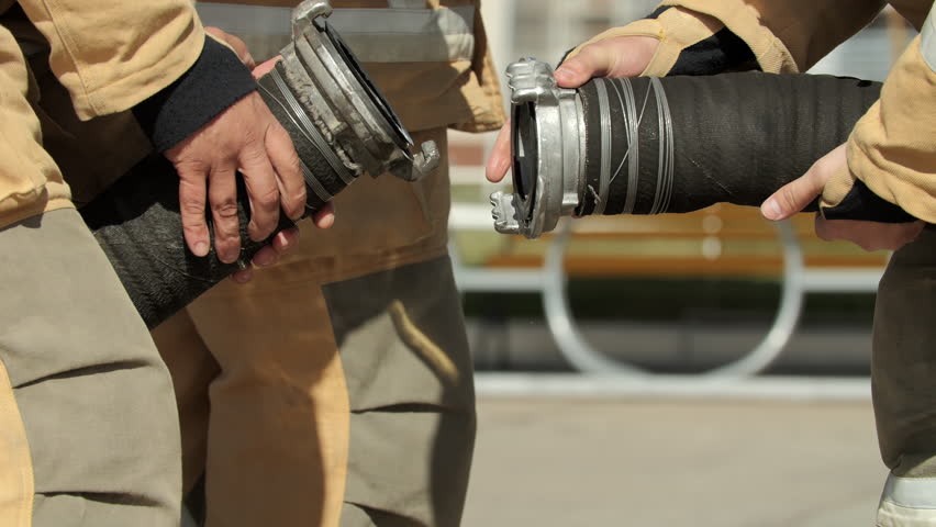 Firefighters Connecting Heavy Water Hose