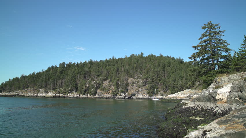 Pacific Northwest Rocky Shoreline Sunshine 4K UHD.Looking across a remote rocky shoreline in the Pacific Northwest. 4K UHD.
