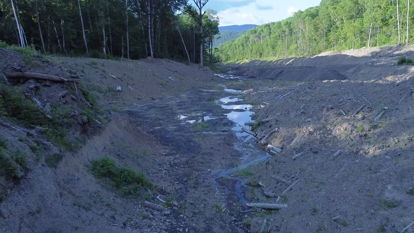 View from above. The Far Eastern taiga. A stream developed by gold miners.