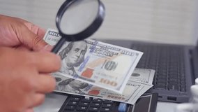 Dollar bills and a magnifying glass. American dollars in a magnifying glass a business background
 - Powered by Shutterstock - Get 15% off with code: PIKWIZARD15