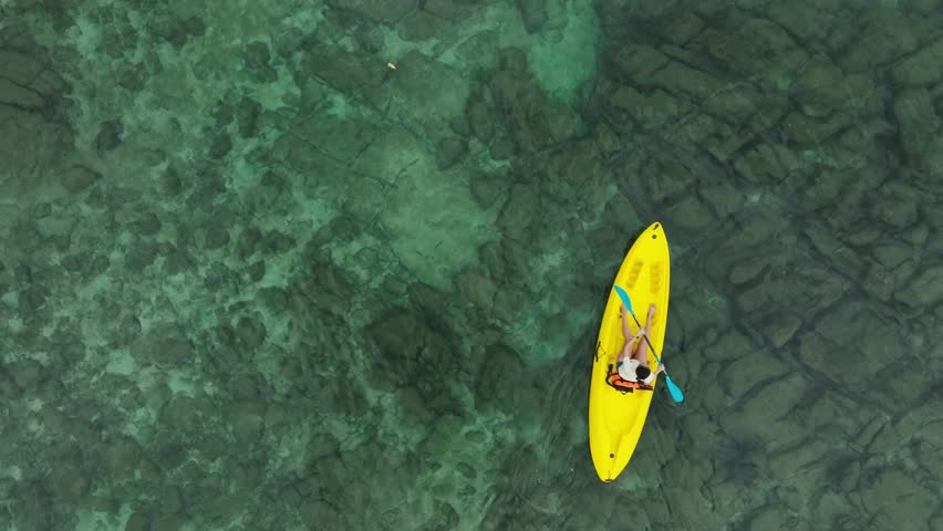 Aerial view of a kayak in the blue sea .Woman kayaking She does water sports activities.