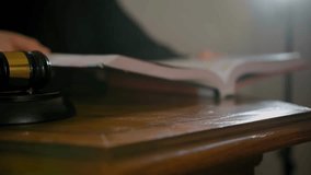 Close-up of a judge’s hand holding a wooden gavel with an American flag in the background, symbolizing law, justice, and the U.S. judicial system. - Powered by Shutterstock - Get 15% off with code: PIKWIZARD15