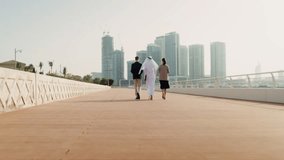 A man and woman in business attire converse with a man in traditional dress, highlighting multicultural professional interaction and cross-cultural business communication. - Powered by Shutterstock - Get 15% off with code: PIKWIZARD15