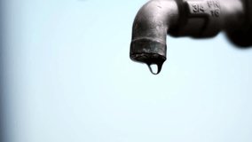 A leaky faucet with water droplets falling downwards. Capturing the simplicity of water conservation and the importance of resource management - Powered by Shutterstock - Get 15% off with code: PIKWIZARD15
