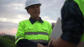 Close-up of a confident site manager or engineer in a safety helmet shaking hands with a colleague, symbolizing trust, partnership, and successful project completion on an industrial site at dusk - Powered by Shutterstock - Get 15% off with code: PIKWIZARD15
