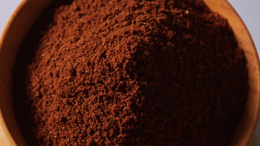 coffee powder into a wooden cup.
