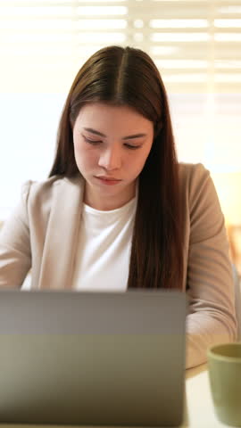 Asian businesswoman sitting at desk in office feeling tired, adult female professional resting head on hand, stress, fatigue, work pressure mental exhaustion during late night business task management