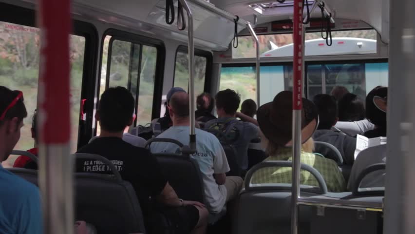 Tourists sitting on a shuttle at Zion National Park in Southern Utah