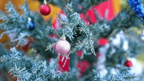 Festive Celebration with Beautifully Decorated Christmas Tree Adorned with Colorful Ornaments, Shiny Pink Bauble, and Frosted Green Branches for Holiday Decoration - Powered by Shutterstock - Get 15% off with code: PIKWIZARD15