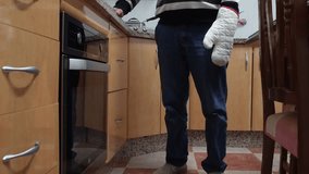 Senior man cooking pizza taking tray from oven - Powered by Shutterstock - Get 15% off with code: PIKWIZARD15