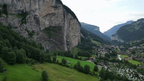 Cinematic aerial drone footage of Staubbachfall waterfall dropping from a high cliff into the Lauterbrunnen valley in the Swiss Alps. - Powered by Shutterstock - Get 15% off with code: PIKWIZARD15
