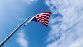 A low-angle view of the American flag waving against a bright blue sky with soft clouds. Perfect for Veterans Day, Independence Day, Memorial Day, and Fourth of July themes, symbolizing patriotism. - Powered by Shutterstock - Get 15% off with code: PIKWIZARD15