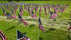 A powerful aerial view of a sea of U.S. flags waving together in honor of July 4th, Independence Day, Memorial Day, and Veterans Day. A patriotic tribute symbolizing unity, pride, and American freedom - Powered by Shutterstock - Get 15% off with code: PIKWIZARD15