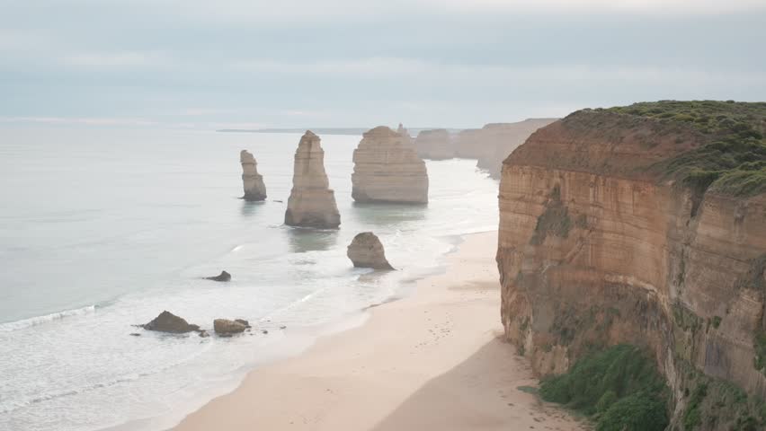 Iconic view of the Twelve Apostles limestone stacks along the Great Ocean Road. Scenic cliffs and sandy beach meet the Southern Ocean in Port Campbell National Park, Victoria, Australia.