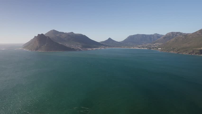 Panoramic view of Hout Bay and coastal mountains from Chapman’s Peak view point, Cape Town, Cape Peninsula, Western Cape, South Africa. Iconic tourist destination. 30fps footage captured in 4k 60p.