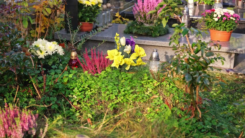 Neglected Grave Tombstone with Old Fake Plastic Flowers Decoration Overgrown with Grass