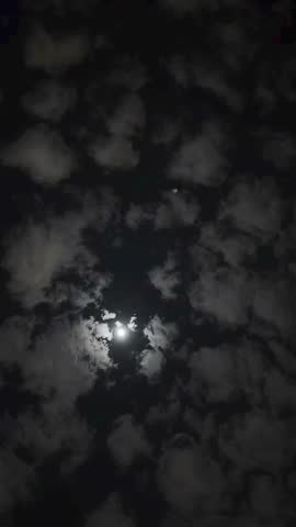 Mystical Night Sky with Clouds Illuminated by the Moon
