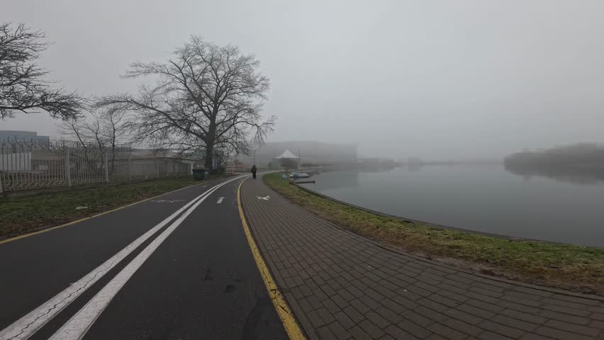 Bike path. Daytime bike ride. Active tourism, athlete, rides, driver, active lifestyle, sports. Line, road, grass, wheel. Walking in the rain.