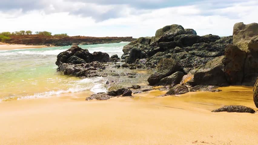 Volcanic Boulders And White Sand on The Shore of Kawakiu Beach, Molokai, USA