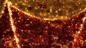 Footage of sparkling christmas tinsels arrangement background, illuminated with twinkle icicle lights. tinsels garland in gold and red colors. Christmas festive decoration. Merry Christmas - Powered by Shutterstock - Get 15% off with code: PIKWIZARD15