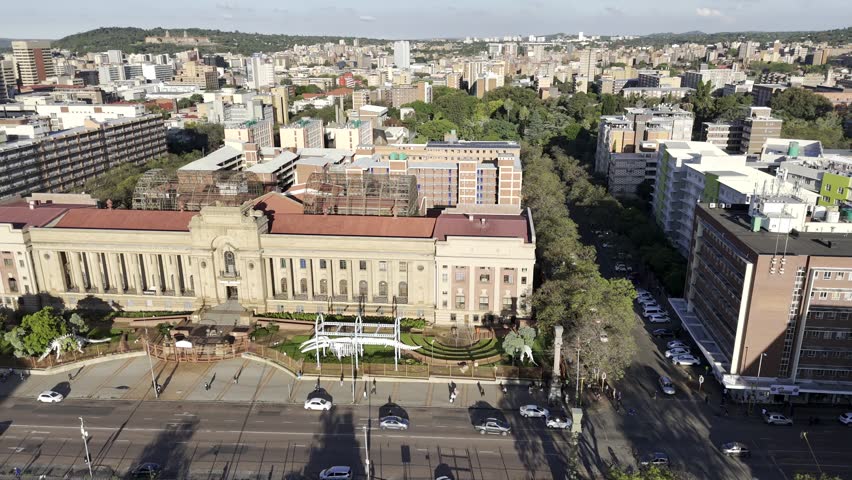 Drone flies to the left in front of the natural history museum in the late afternoon in Pretoria, South Africa