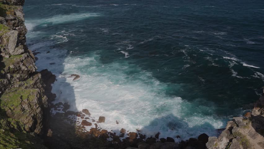 Detail of water and waves surging below the cliffs at Cape of Good Hope. Table Mountain National Park. Cape Town. Western Cape. South Africa.